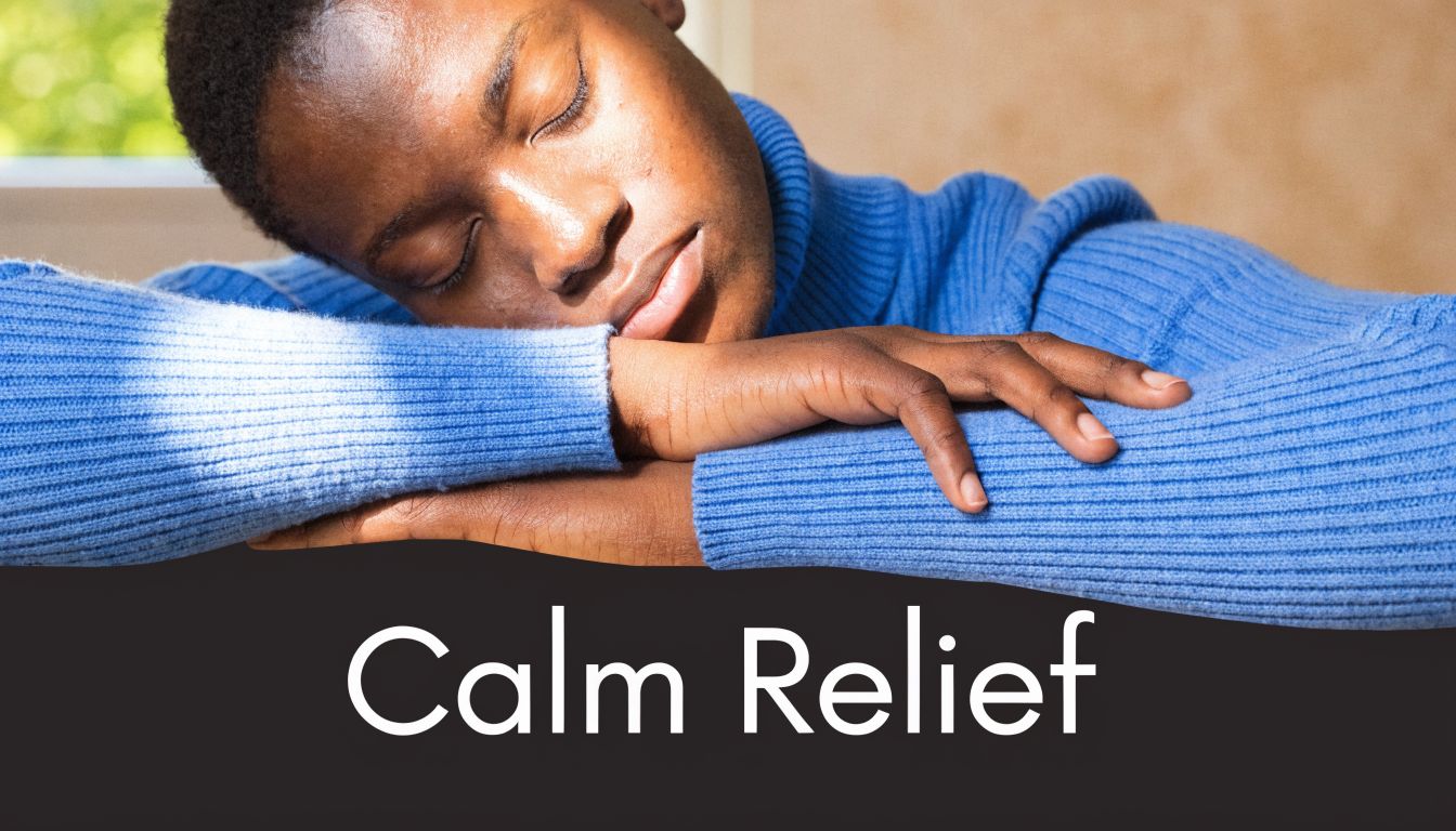 A person wearing a blue turtleneck sweater resting their head peacefully on their folded arms.